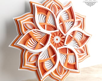 May include: A layered papercraft mandala design with intricate details in orange and white. The design is reminiscent of a flower with multiple layers of petals.