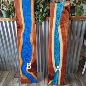 May include: Two long wooden boards with a blue resin river running through the center. The boards are labeled "A" and "B".