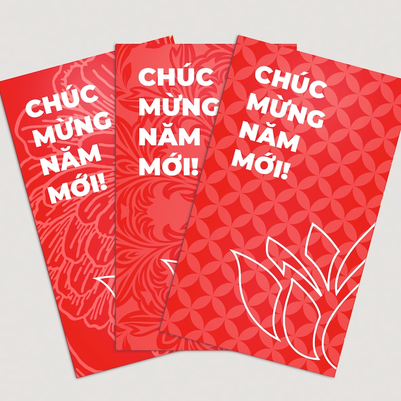 May include: Three red envelopes with white text that reads "Chuc Mung Nam Moi!" which translates to "Happy New Year!" in Vietnamese. The envelopes have different patterns, including floral and geometric designs.