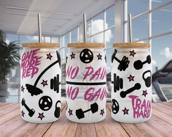 May include: Three white tumblers with black and pink designs. The tumblers have a bamboo lid and a stainless steel straw. The designs include the words "One More Rep", "No Pain No Gain", and "Train Hard".