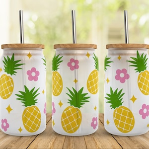 May include: Three white stainless steel tumblers with a wood lid and a straw. The tumblers have a pineapple and flower pattern in pink, yellow, and green.