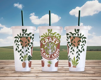 May include: Three white reusable cups with green plant designs. The center cup has the text "Crazy Plant Lady" in a red circle.