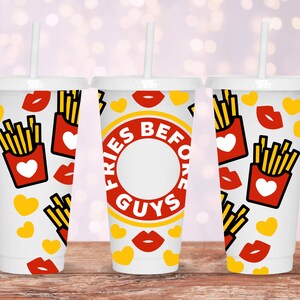 May include: Three white cups with straws and a red, yellow, and white design. The cups have the text "Fries Before Guys" on them.