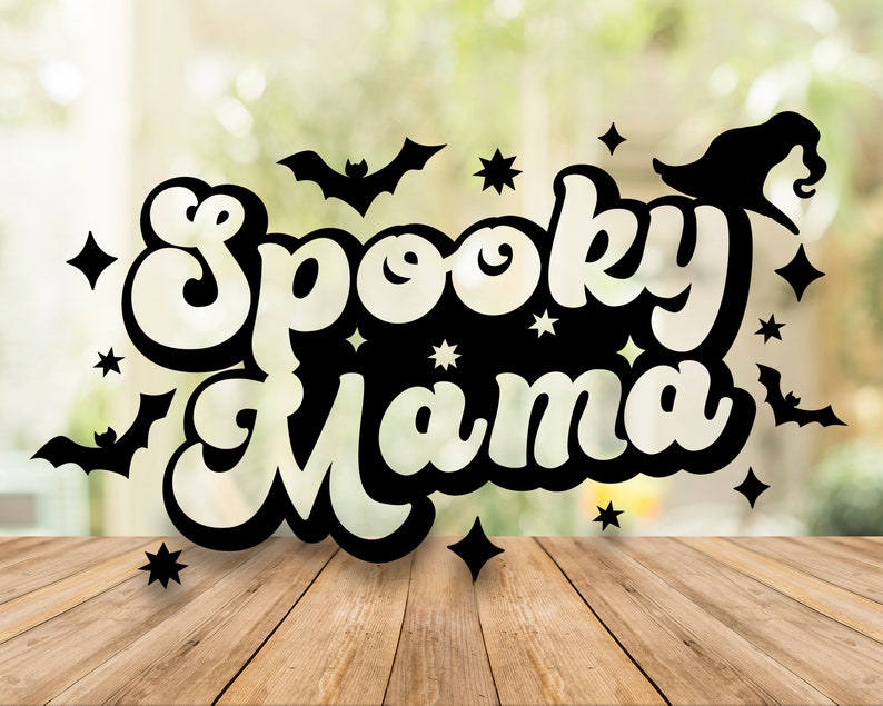 May include: Black and white illustration of the text "Spooky Mama" with bats and stars on a blurred green background.