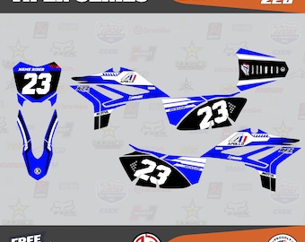 May include: A set of blue and white Viper Series motorcycle decals with the number 23. The decals include the Apollo and RFZ logos, and the text "Name Rider". The design features black accents and the Dunlop logo.