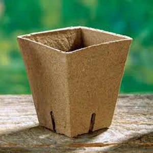 May include: A brown, square-shaped biodegradable pot made from recycled paper. The pot has a textured surface and is designed for planting seedlings or small plants.