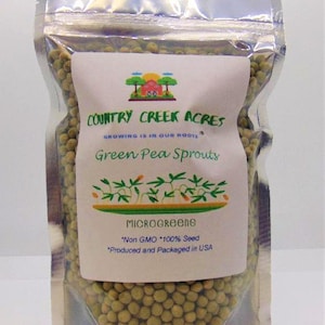 May include: A clear plastic bag filled with green pea sprouts seeds. The bag has a white label with the text "COUNTRY CREEK ACRES", "GROWING IS IN OUR ROOTS", "Green Pea Sprouts", "MICROGREENS", "Non GMO 100% Seed", and "Produced and Packaged in USA".