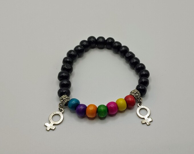 Black Wooden Beaded Bracelet With A Section Of Rainbow Coloured Beads With Two Female Gender Symbols.