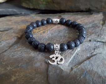 Black Lava Stone Diffuser Bracelet With a Tibetan Silver Buddha Spacer Bead and Om Charm