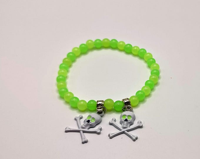 Fluorescent Green Bracelet with Tibetan Silver Spacers and White Skull Charms.