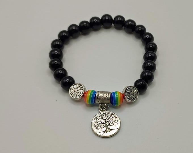 Black Beaded Bracelet With Silver Tree Of Life Spacers And Charm With Rainbow Striped Accent Beads.