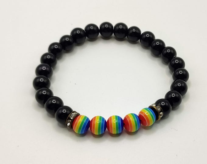 Black Beaded Bracelet With Rainbow Striped Beads And Rhinestone Spacers.