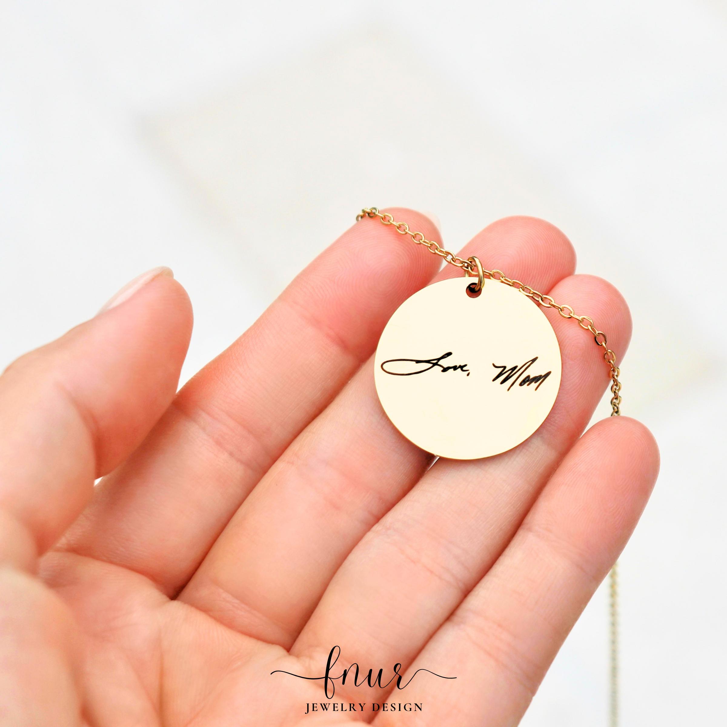 lifestyle shot of woman wearing dainty gold handwriting disc necklace with elegant casual attire