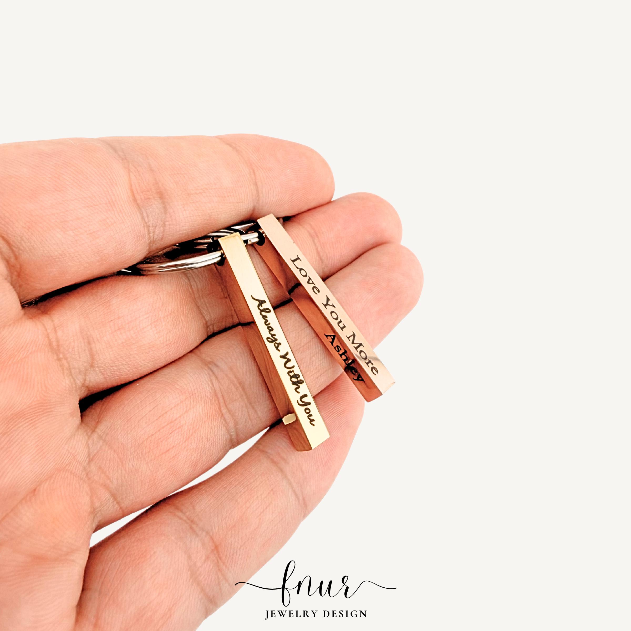 rose gold bar keyring held in hand to show scale and finish
