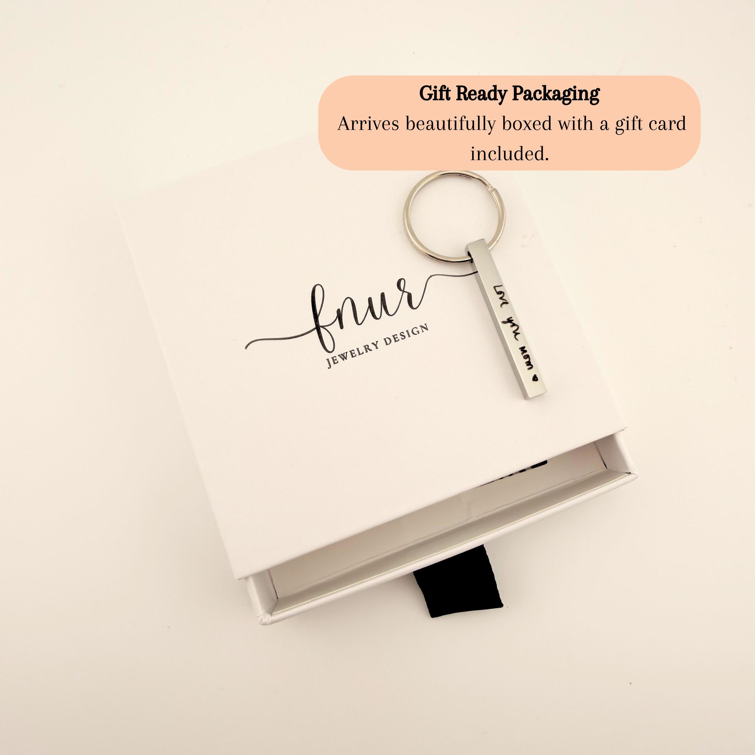 Woman holding custom engraved handwriting keychain showing perfect scale and elegant design for daily use