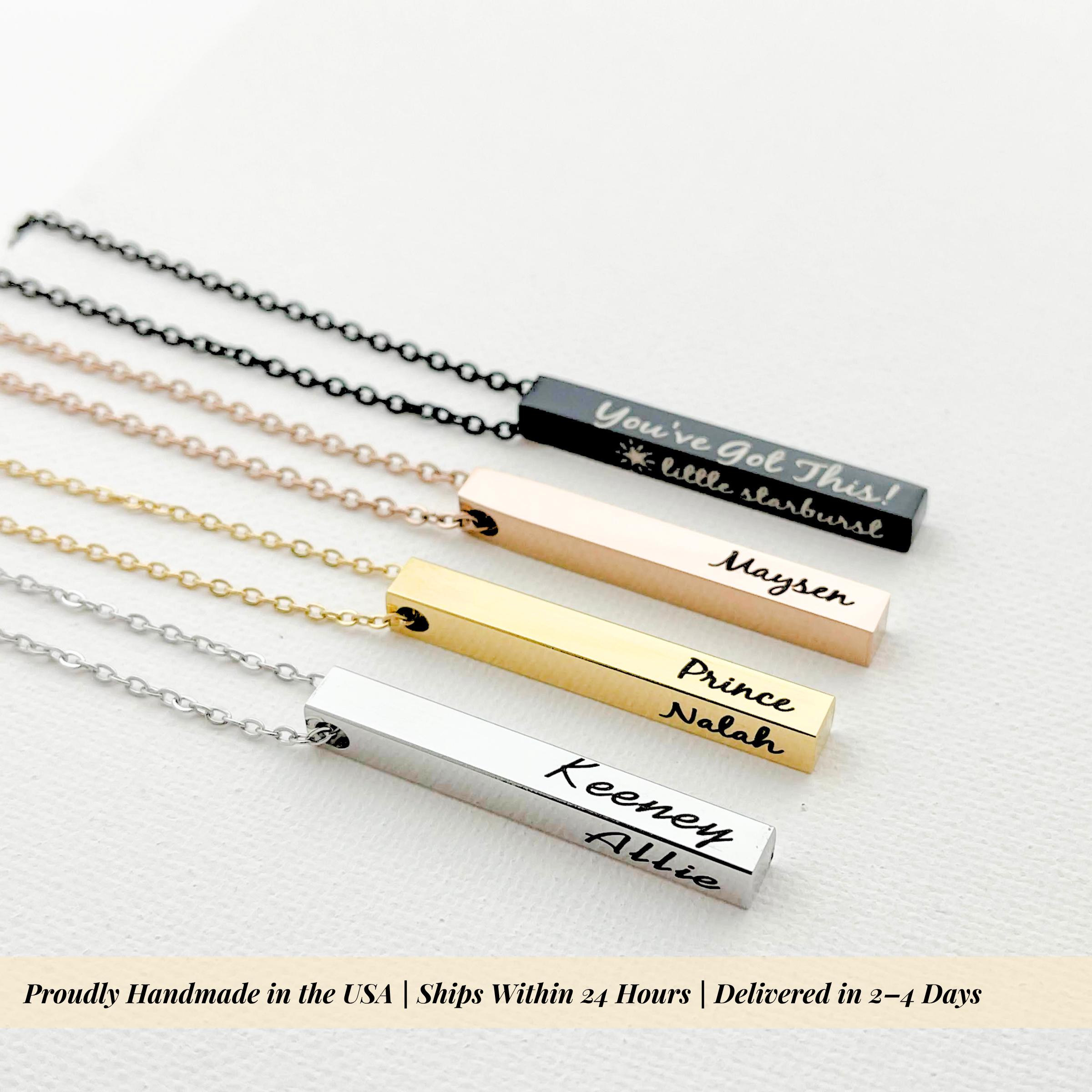 close up macro shot of rose gold bar necklace highlighting precision laser name engraving