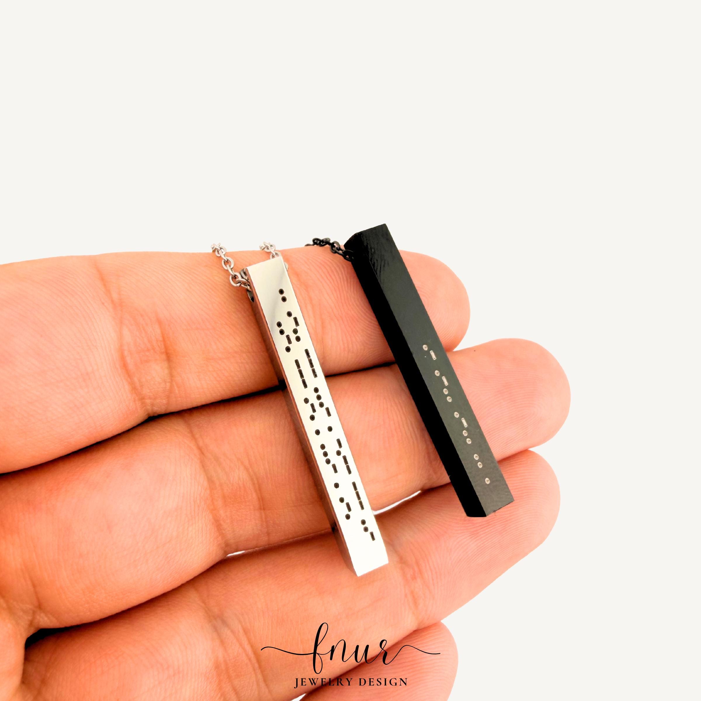 stackable layered jewelry look featuring morse code bar necklace