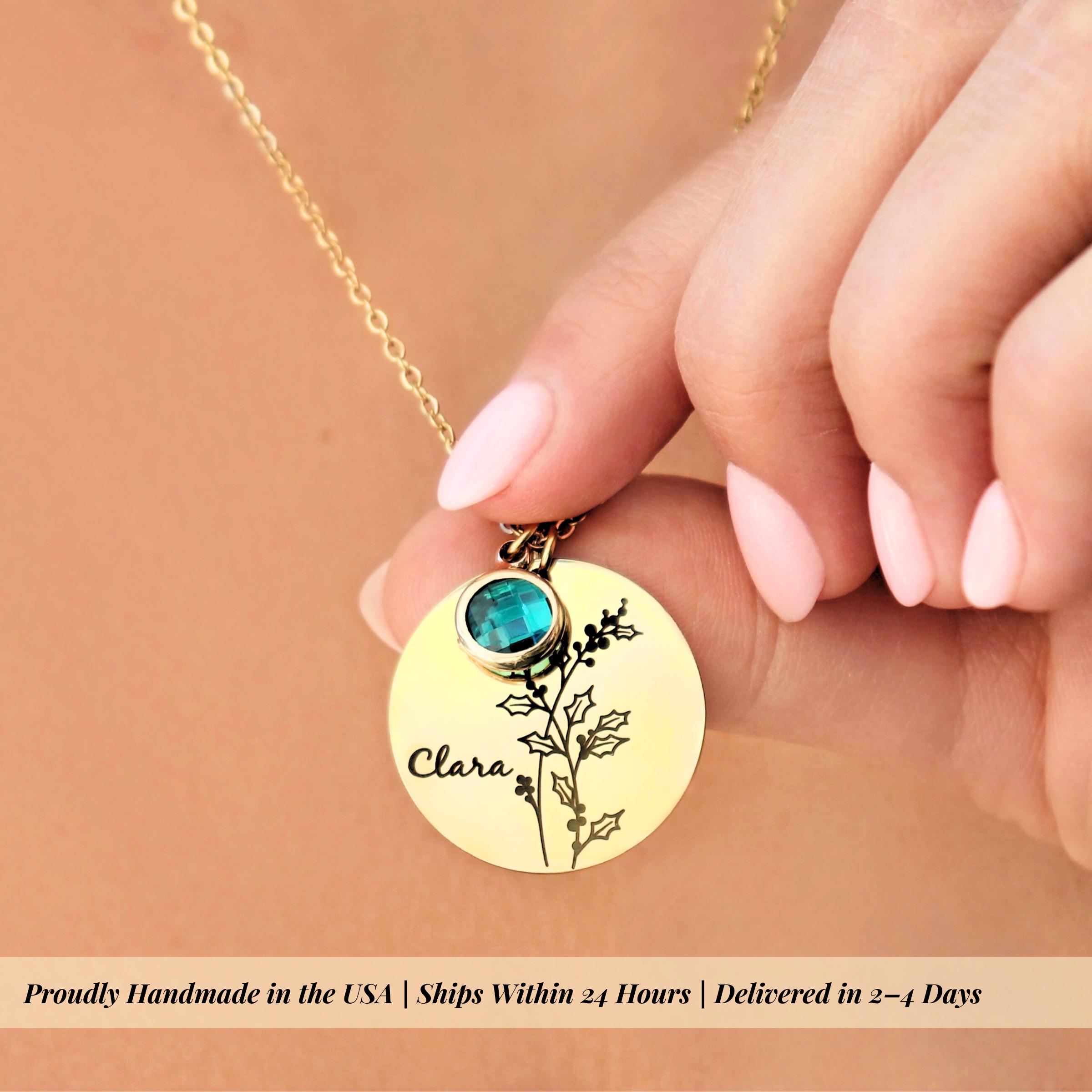 close up macro shot showing delicate birth flower engraving detail on polished gold disc