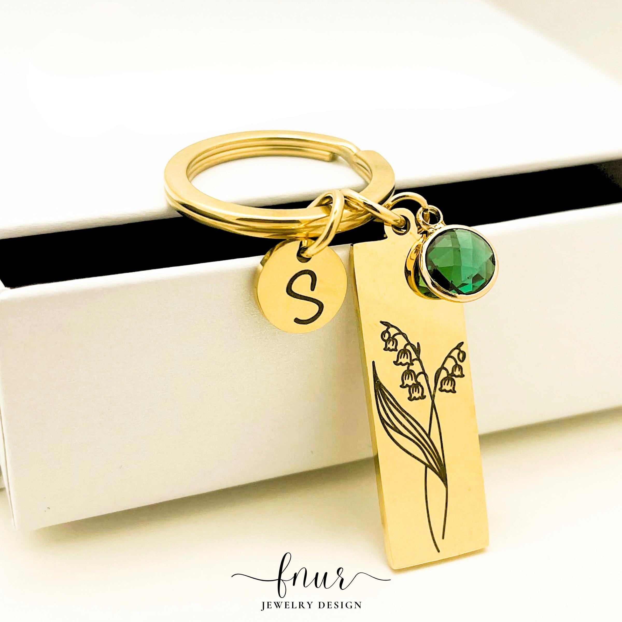Rose gold birth flower keychain featuring custom initial charm and coordinating birthstone crystal accent