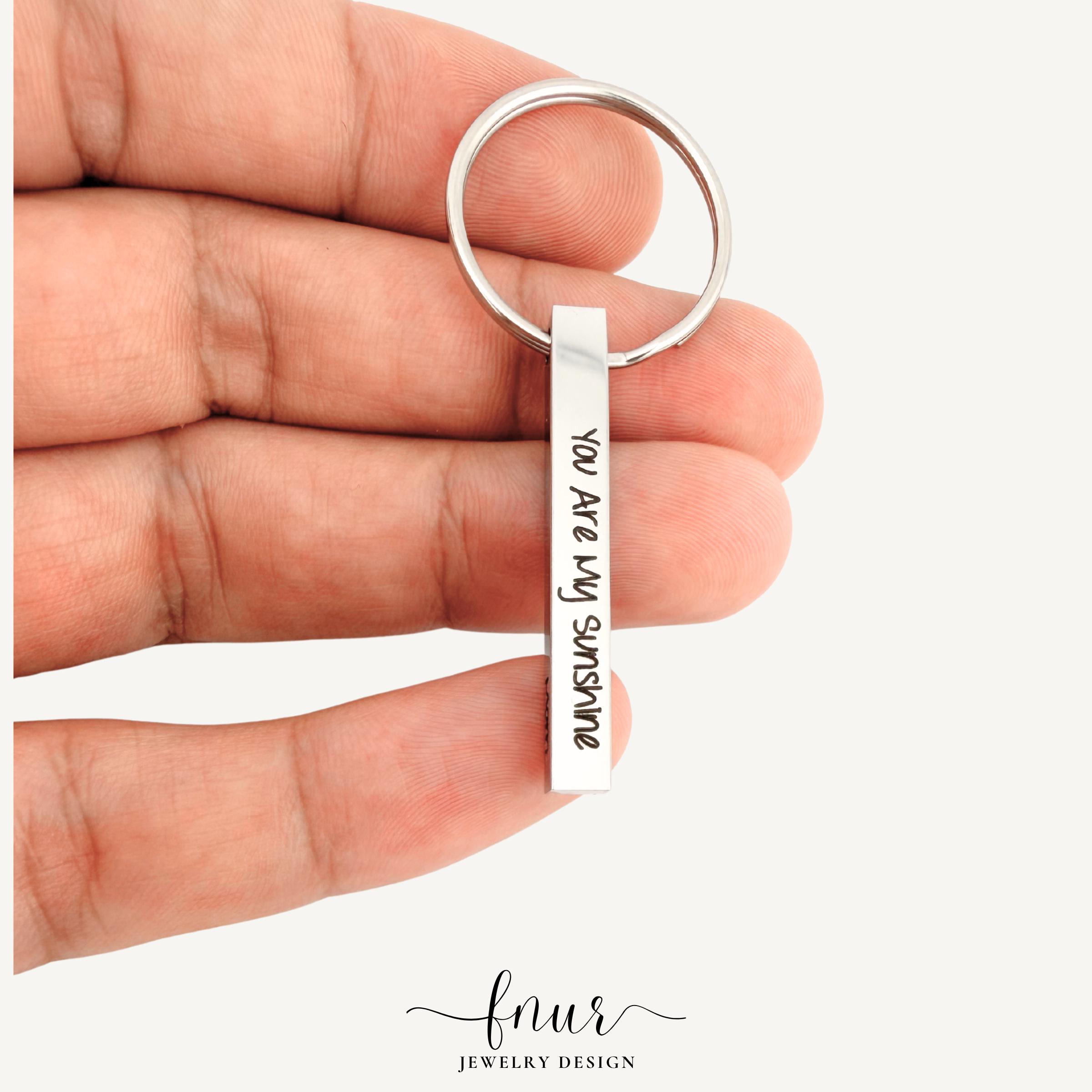 side profile view of engraved bar keychain featuring clean minimalist design lines