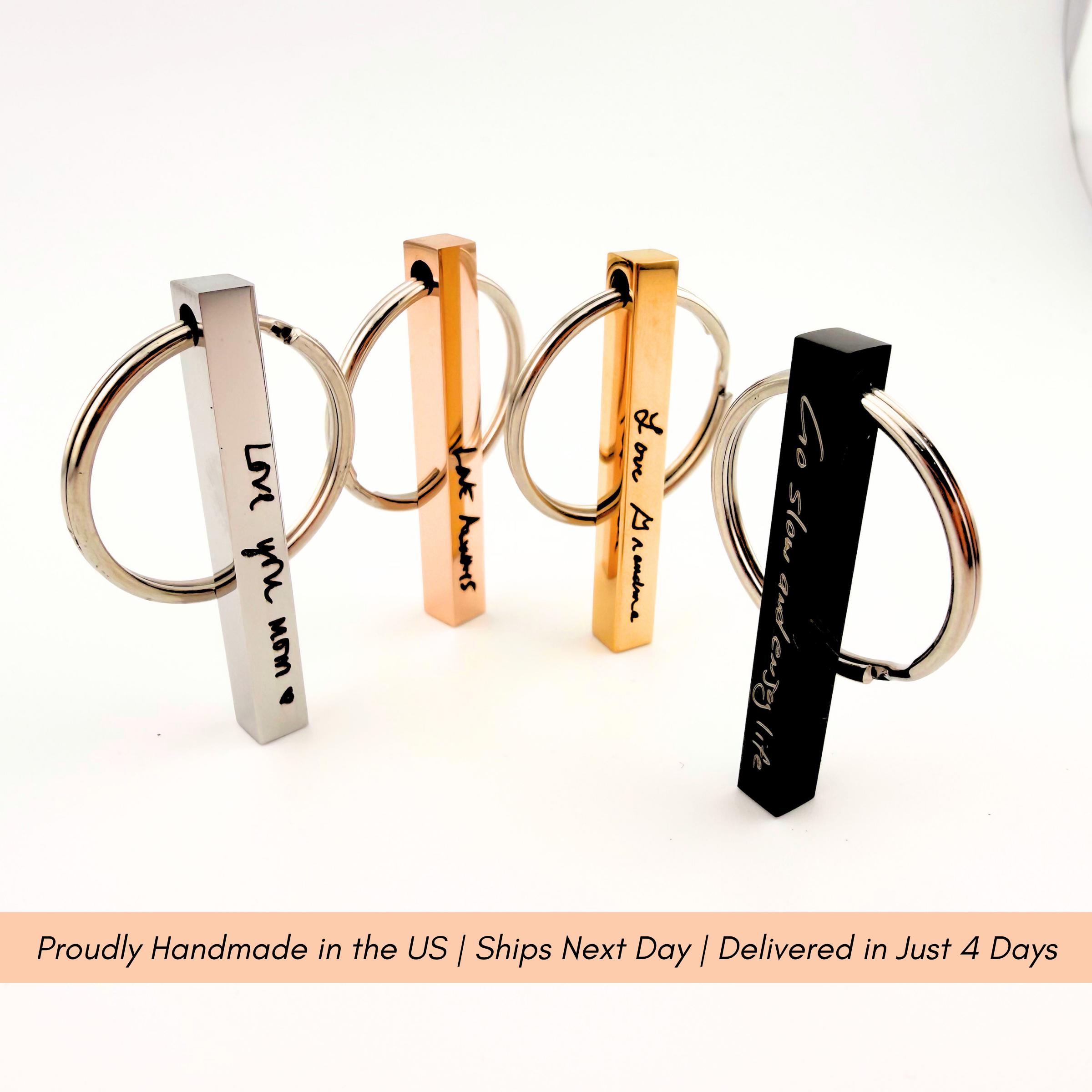 Handwriting keychain displayed on rustic wood surface highlighting the premium tarnish resistant metal finish