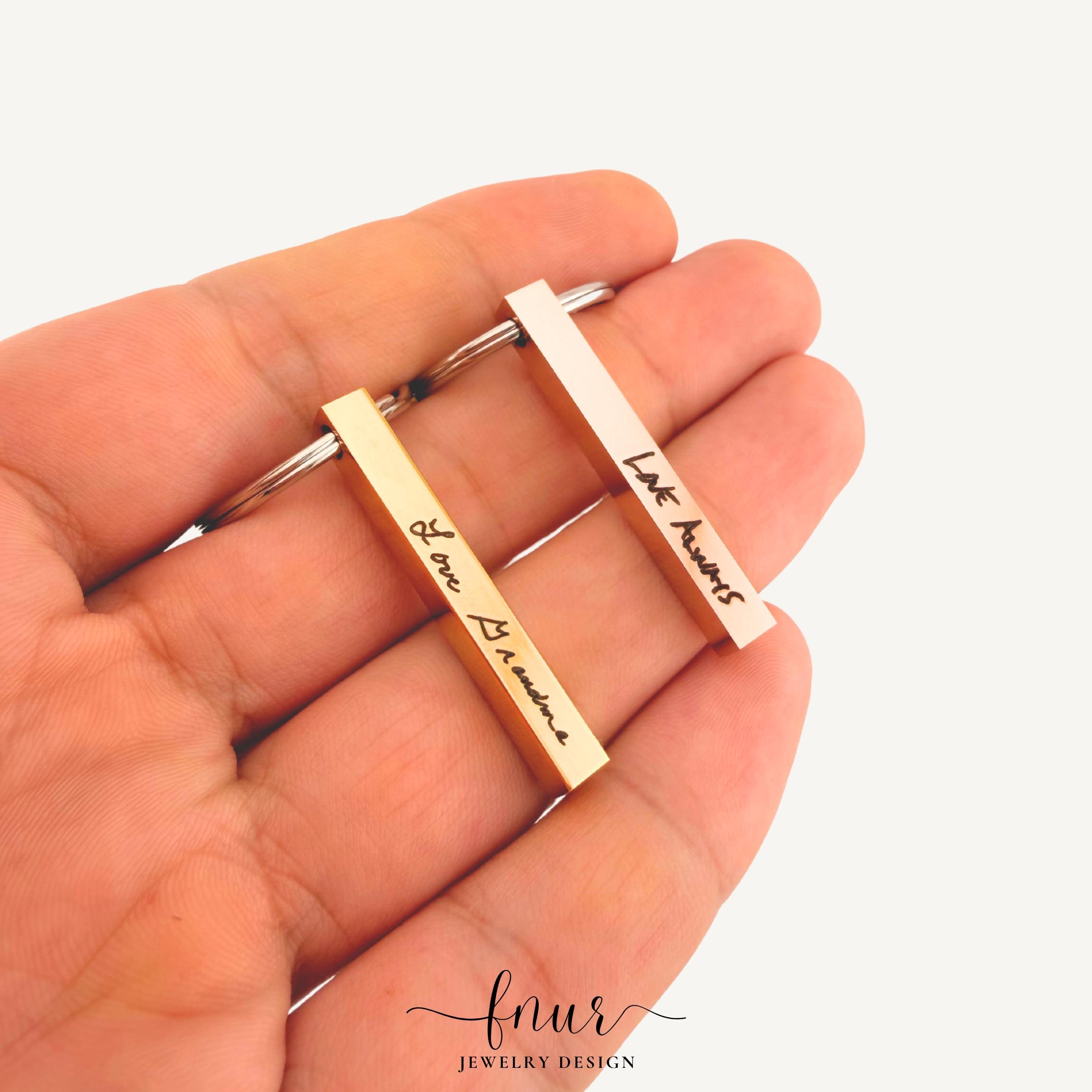 Refined front view of personalized bar keychain showcasing clear legible engraving of actual handwritten note