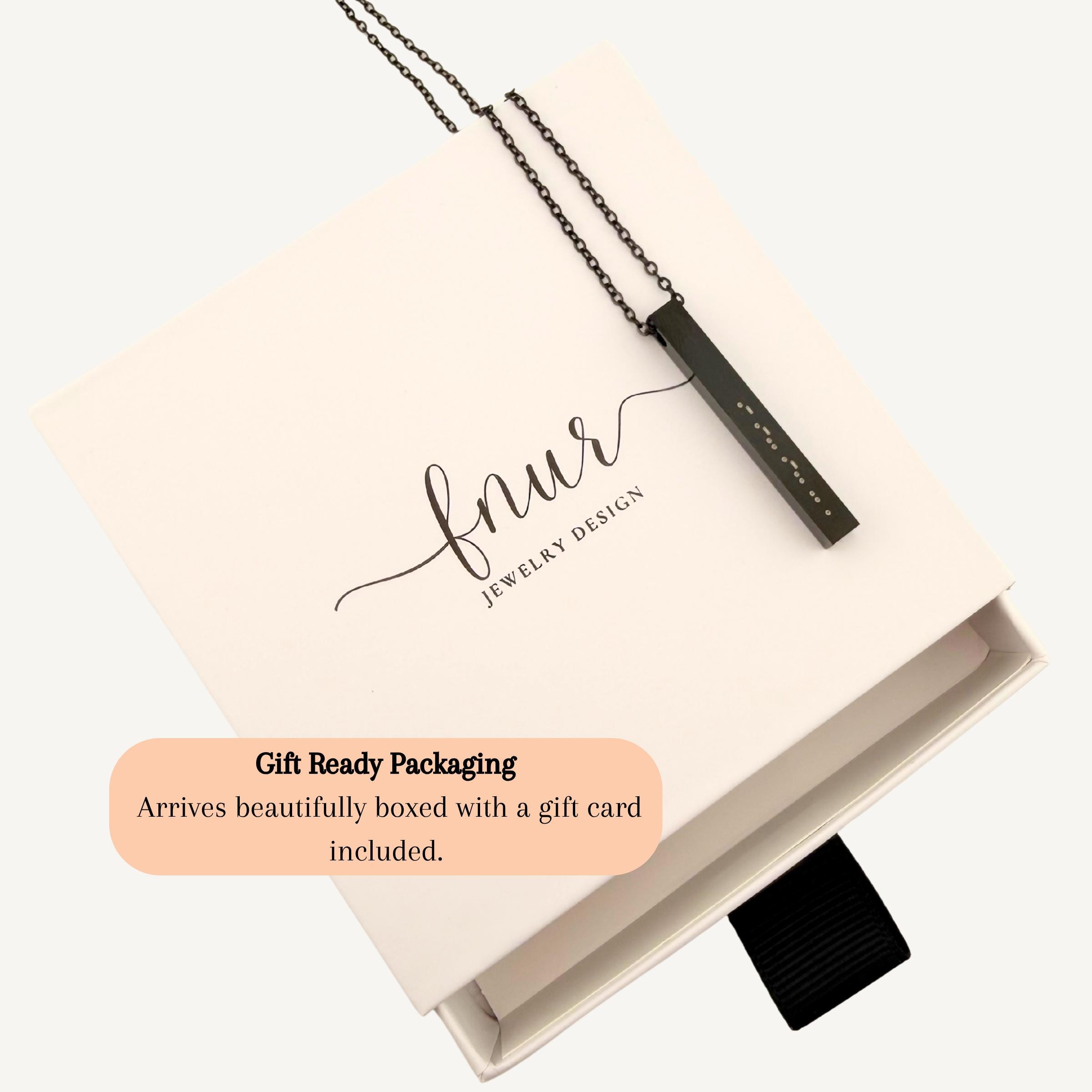 styled flat lay of custom morse code jewelry on white background