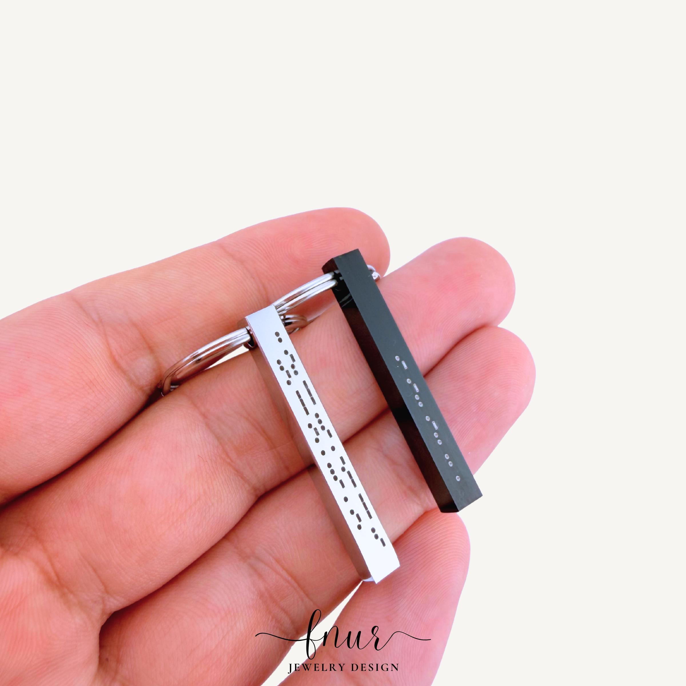 side profile perspective of sturdy stainless steel bar keychain showing elegant minimalist product design