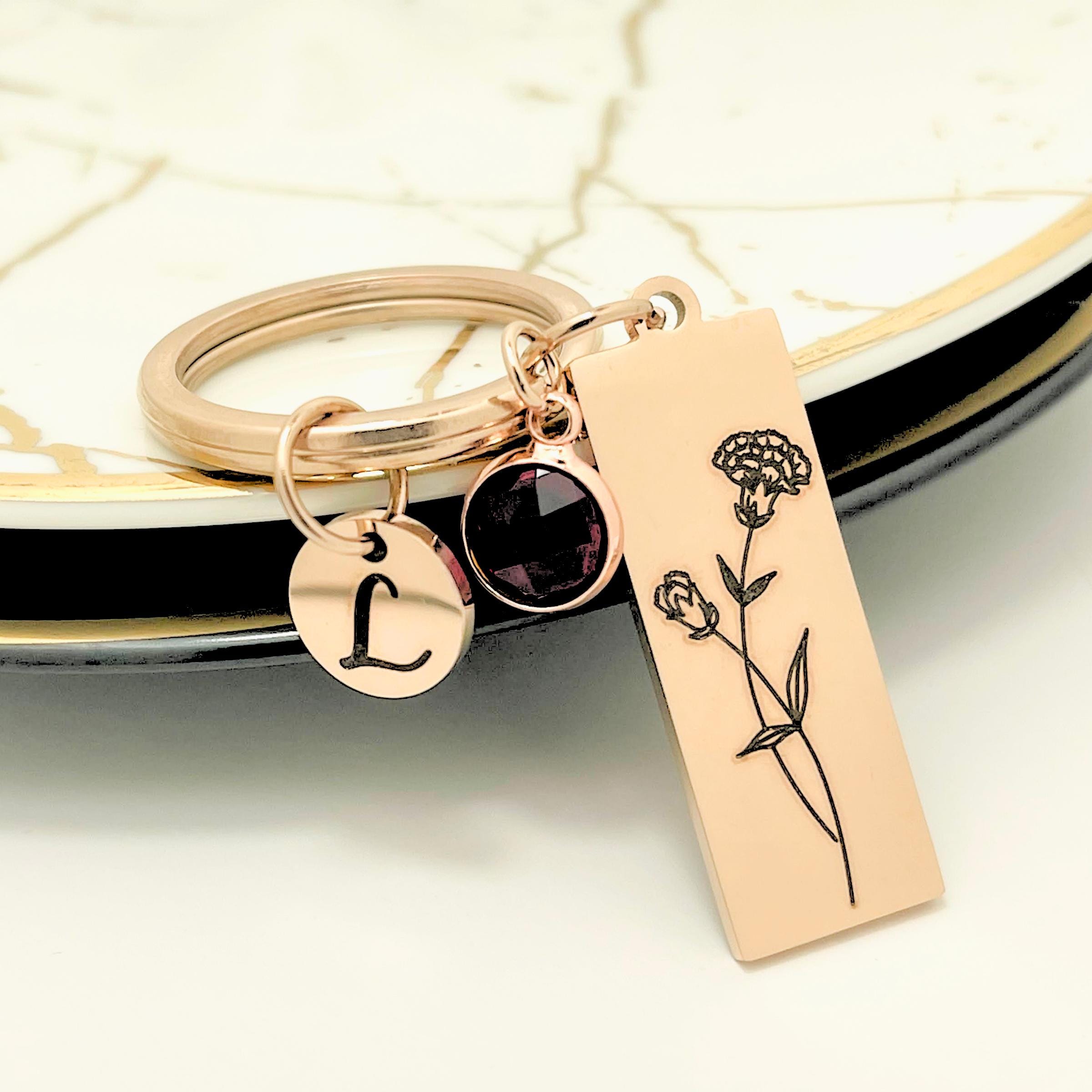 Backside view of polished stainless steel birth flower keyring highlighting smooth high quality finish