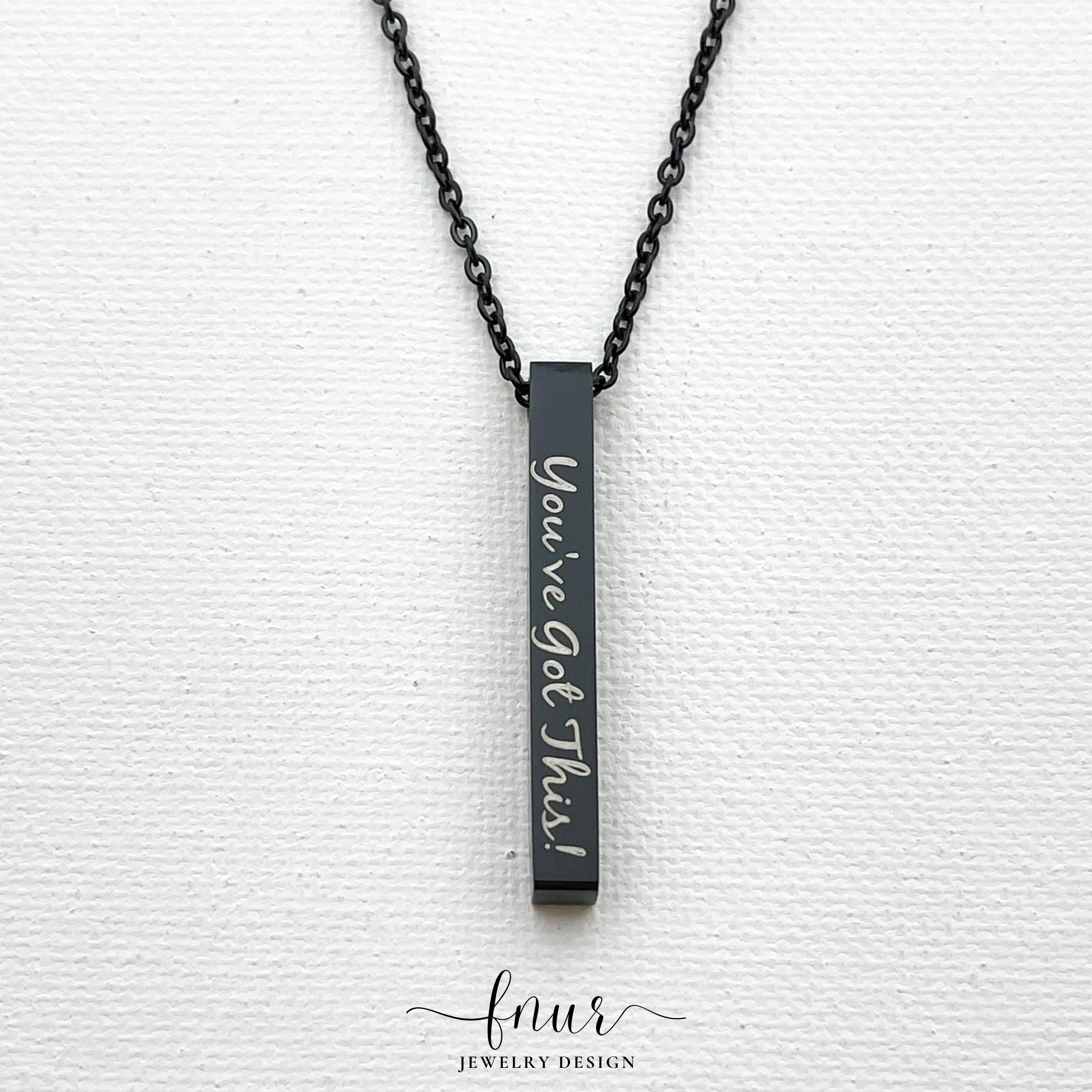 black vertical bar pendant necklace held in hand displaying high polish tarnish resistant texture