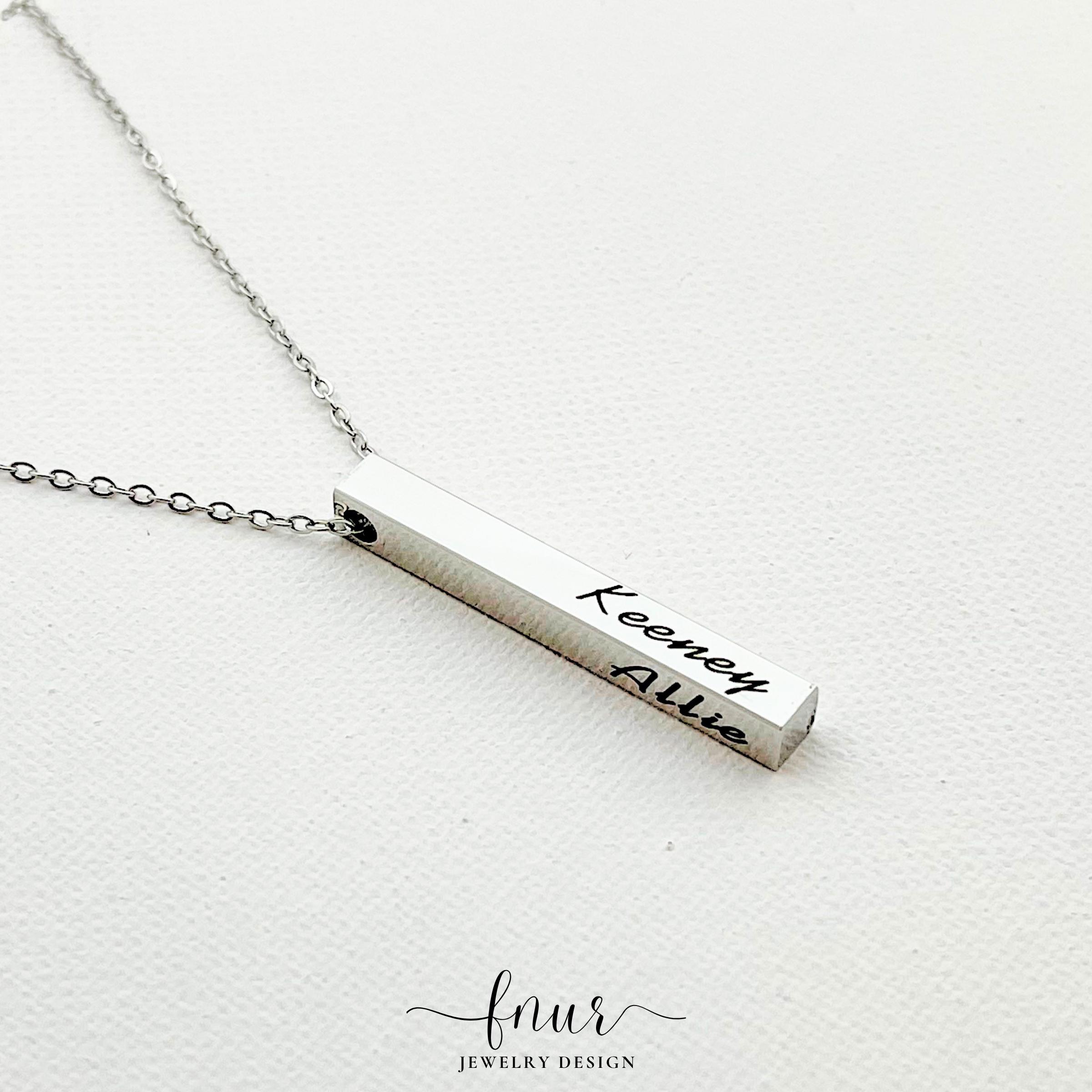 collection of personalized bar necklaces in gold silver and black finishes side by side