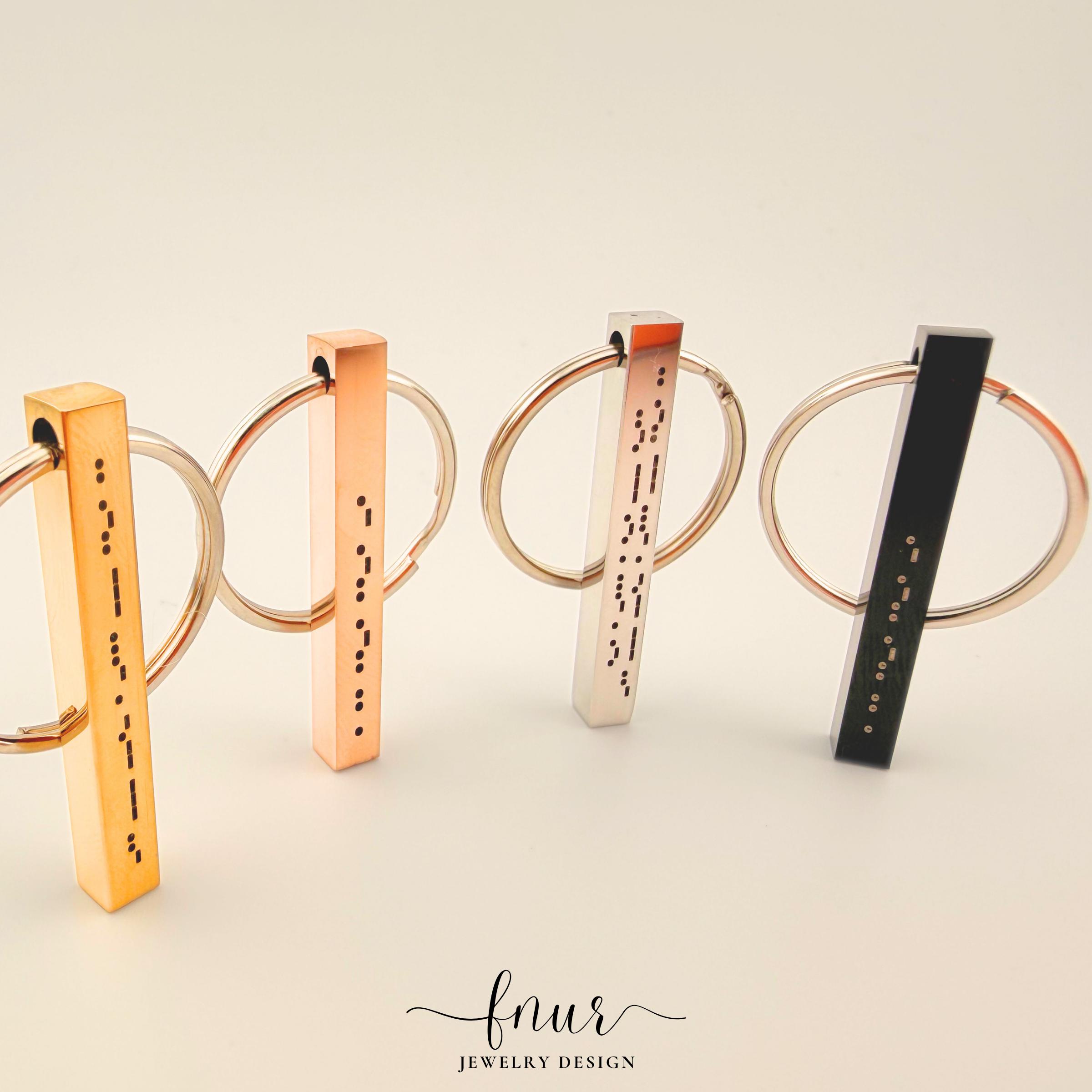 view of personalized morse code keychain attached to modern leather keychain and brass hardware