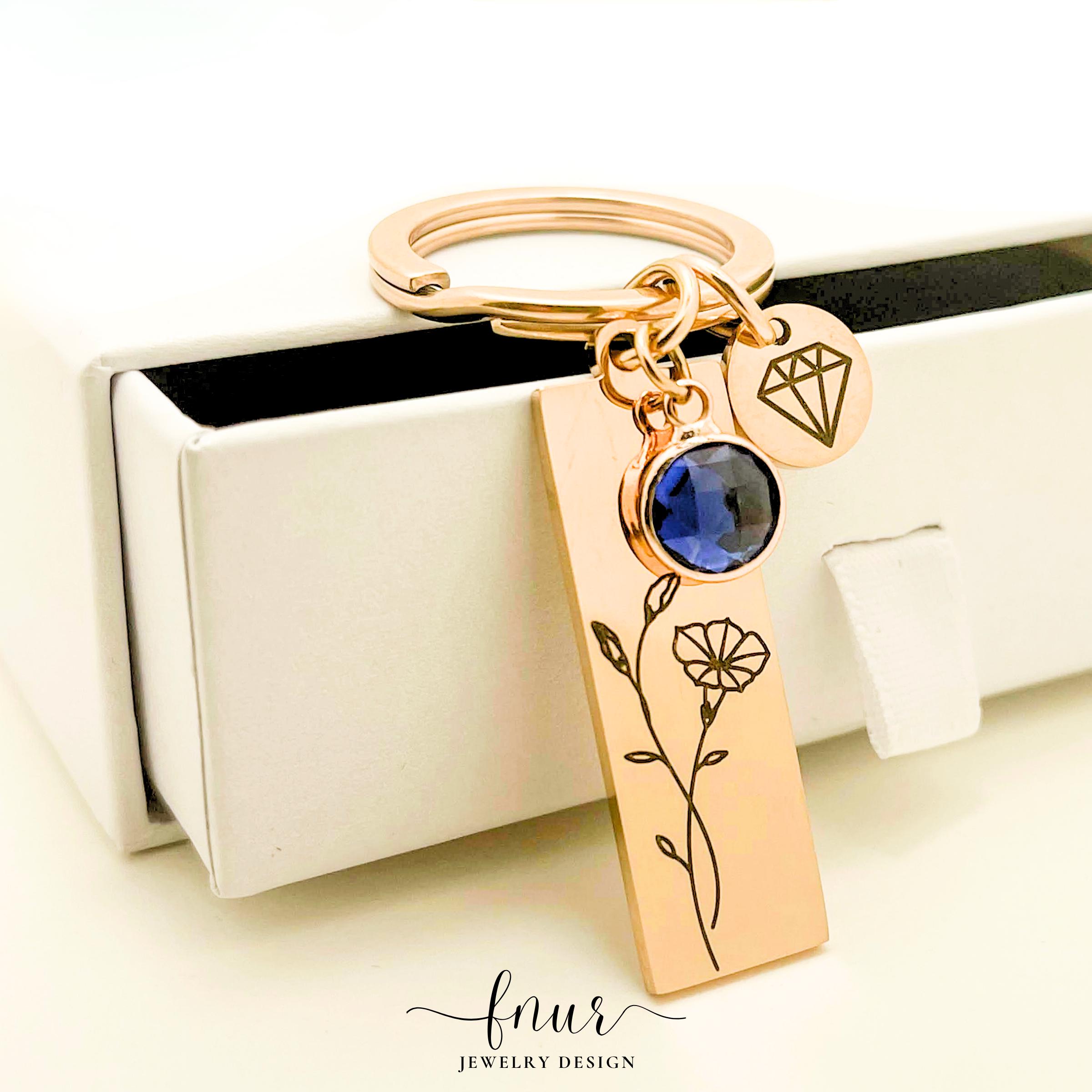 Silver birth flower keyring displayed elegantly on a clean white background for gift presentation