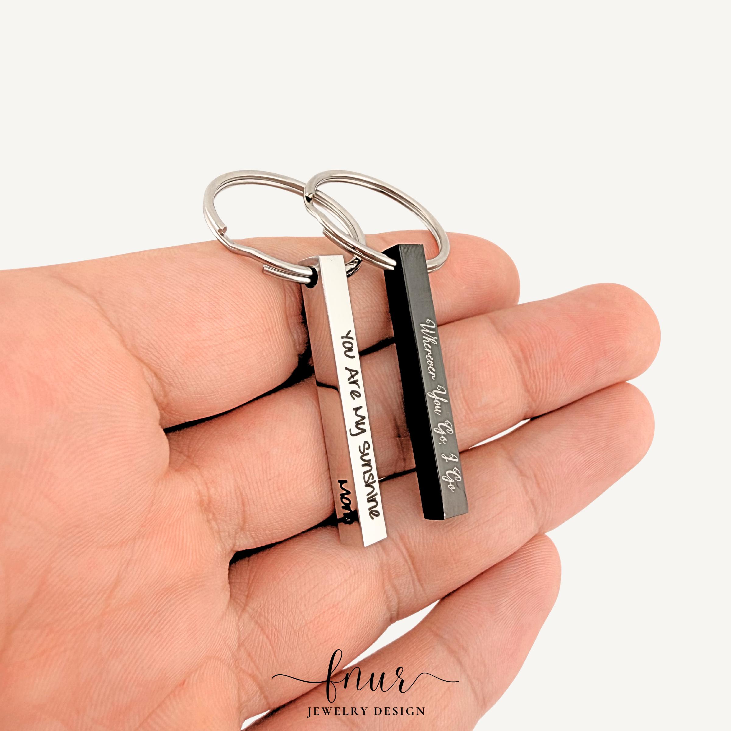 close up shot of detailed laser engraving on stainless steel bar keychain