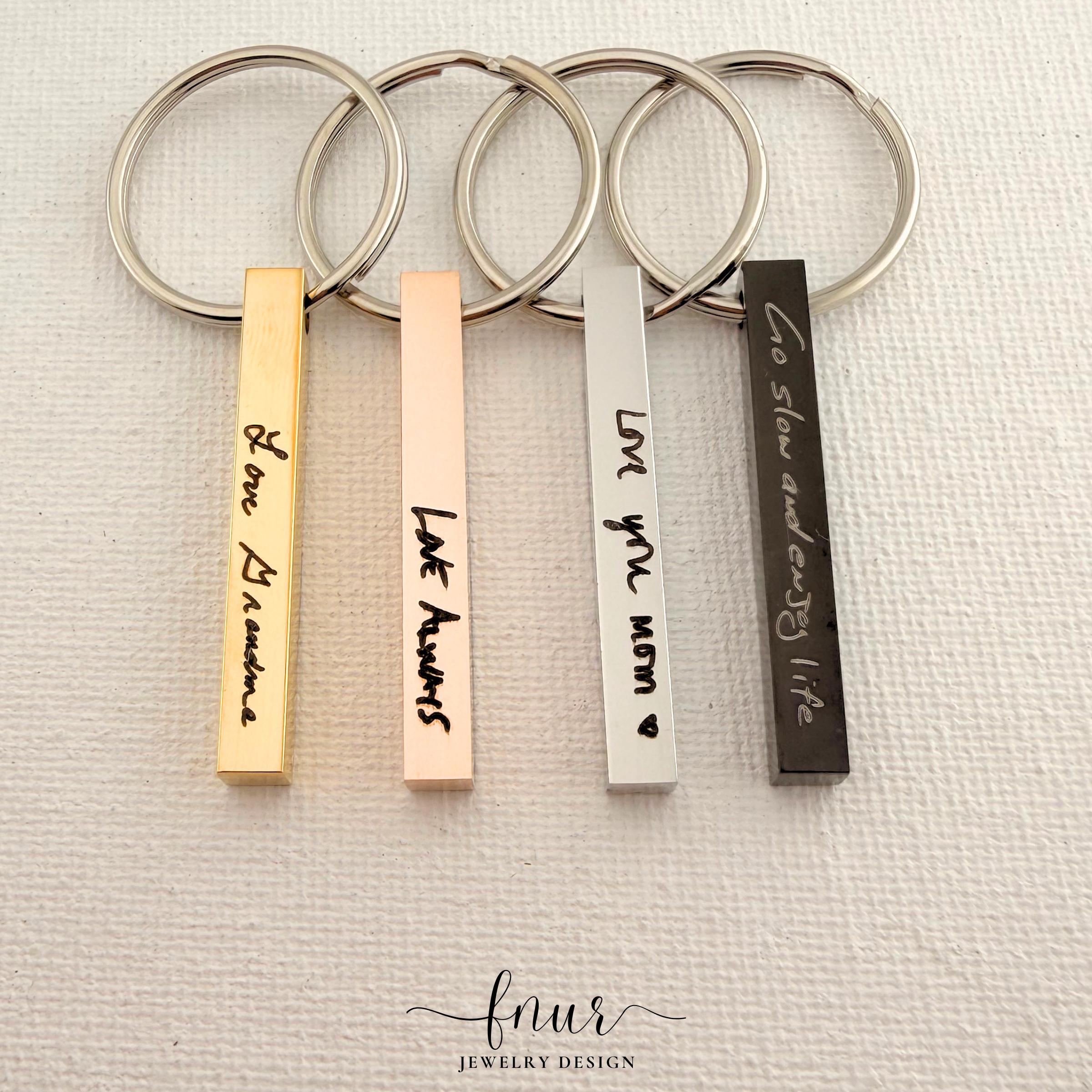 Lifestyle composition of personalized signature keychain resting beside leather bag highlighting versatile accessory style
