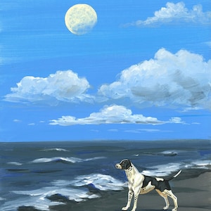 May include: A black and white spotted dog stands on a beach, looking out at the ocean. The sky is blue with white clouds and a full moon.