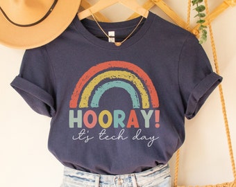 May include: A navy blue t-shirt with a rainbow graphic and the text "HOORAY! It's tech day".