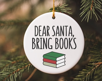 May include: White ceramic Christmas ornament with the text "Dear Santa, Bring Books" and a green, red, and white stack of books.