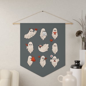 May include: A gray tapestry with a white background featuring nine different illustrations of ghosts with red hearts, flowers, and a sign that says "I love you".