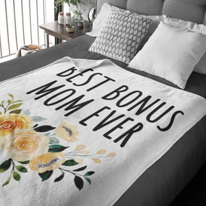 May include: White throw blanket with a floral design and the text "Best Bonus Mom Ever" in black.
