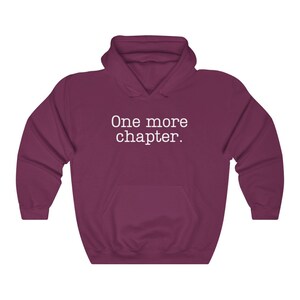 May include: A maroon hooded sweatshirt with the text "One more chapter." printed in white on the front.