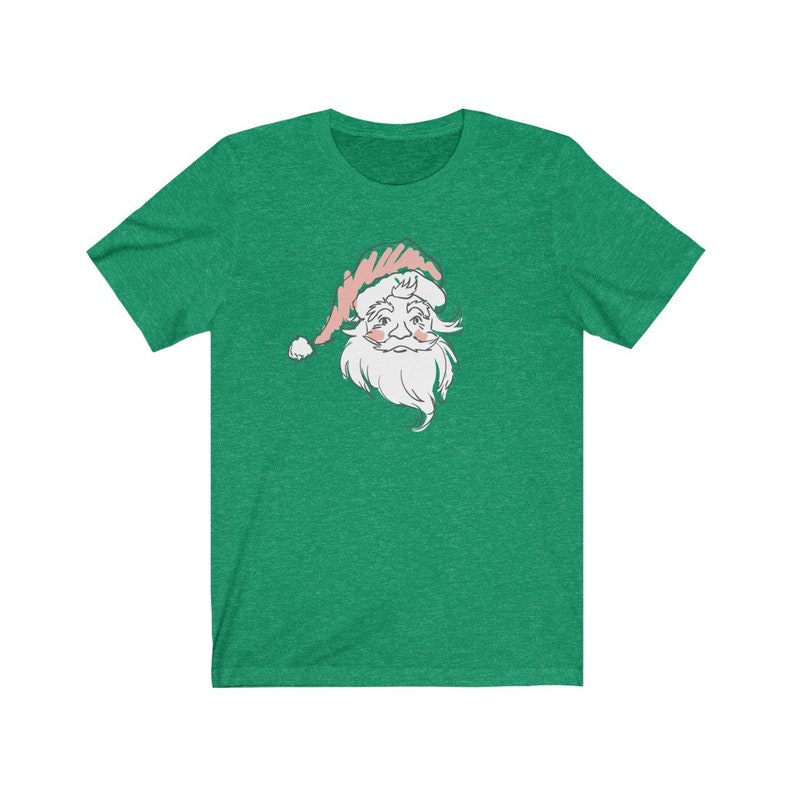 May include: A green t-shirt with a white and pink illustration of Santa Claus's face.