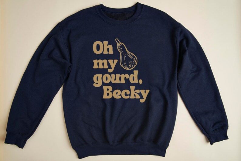 May include: A navy blue sweatshirt with a gold graphic that says "Oh my gourd, Becky" with a gourd illustration.