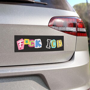 May include: Black rectangular car magnet with the text "F*CK ICE" in colorful, cut-out style letters. The magnet is affixed to the rear of a silver car.