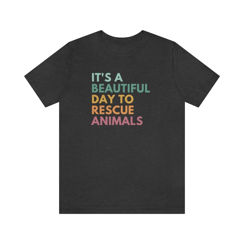 May include: A dark heather grey t-shirt with the text "It's a beautiful day to rescue animals" in rainbow colors.
