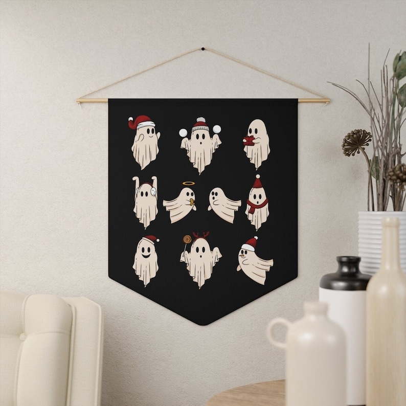 May include: A black fabric tapestry with a white ghost wearing a Santa hat and holding a candy cane. The tapestry features 12 different ghosts in various holiday poses.