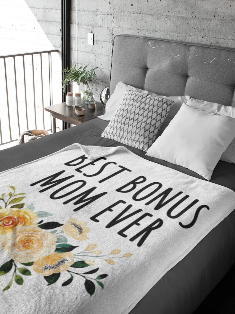 May include: White throw blanket with a floral design and the text "Best Bonus Mom Ever" in black.