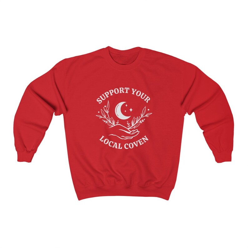 May include: Red sweatshirt with a white graphic design that says "Support Your Local Coven" with a crescent moon and stars.