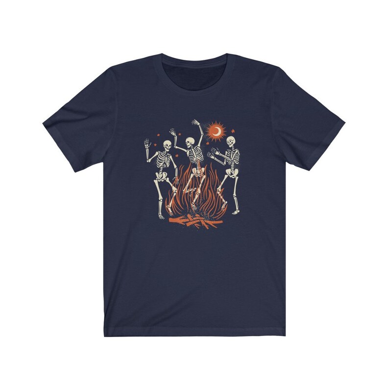 May include: Navy blue t-shirt with a graphic of three skeletons dancing around a campfire with a crescent moon and sun in the background.