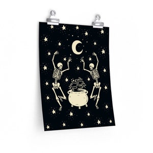 May include: A rectangular wall poster featuring a black background with a cream-colored crescent moon and scattered stars. Two skeletons are positioned on either side of a central steaming cauldron, with their arms raised toward the moon.